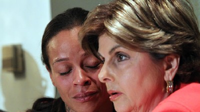 Attorney Gloria Allred, right, speaks as she puts her arm around Dayana Mejia during a news conference, Friday, Oct. 4, 2013, in New York. Mejia, the longtime girlfriend of biker Edwin Mieses Jr., who was struck by an SUV during a bloody weekend confrontation with a throng of motorcyclists, says he is a devoted family man.